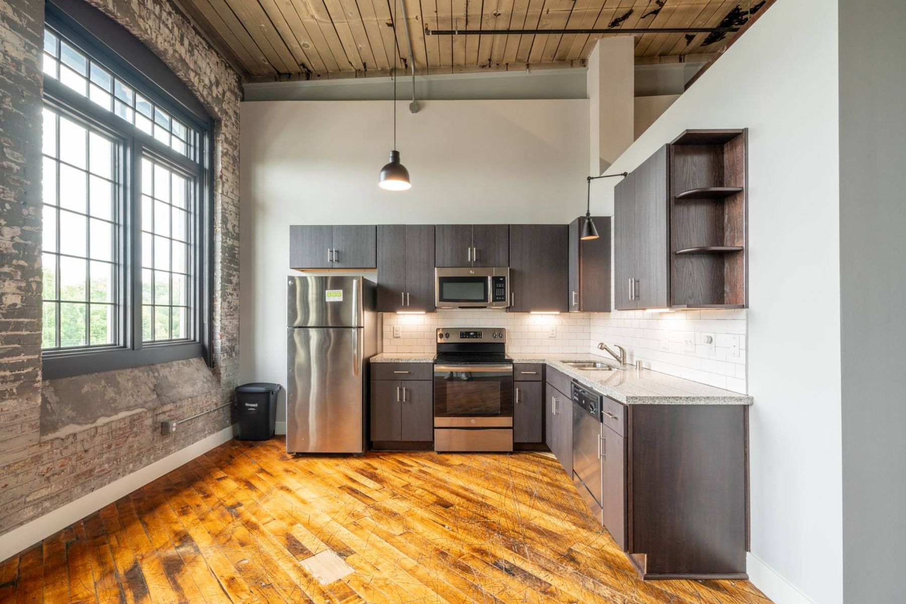 Luxury apartment kitchen with stainless steel appliances, granite countertops, and lots of storage space